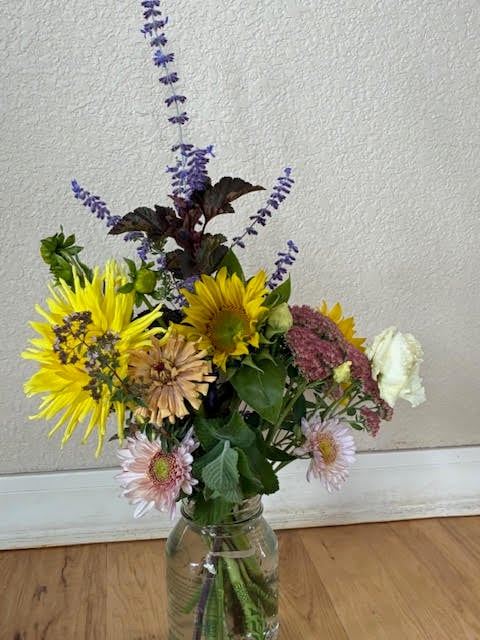 mostly pastel coloread bouqet - sunflowers, zinnia, mum, lisianthus, russian sage, sedum
